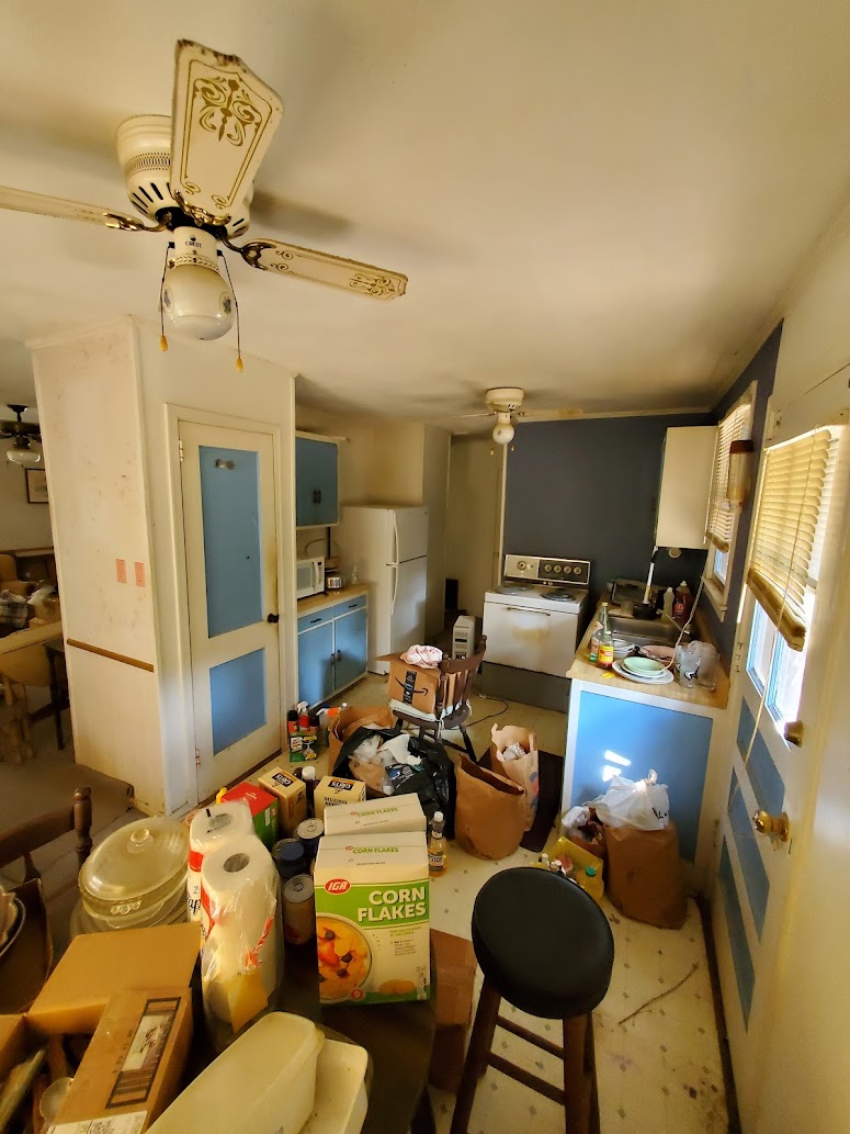 Kitchen with belongings and items - we buy houses in any condition